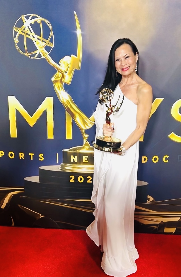 Kim holding Emmy Award